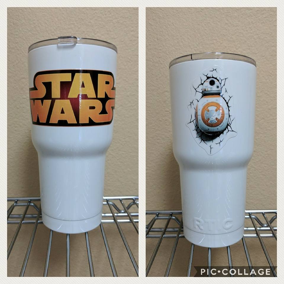 Two white tumblers with Star Wars logos on a metal rack. One with the Star Wars logo, the other with BB-8.