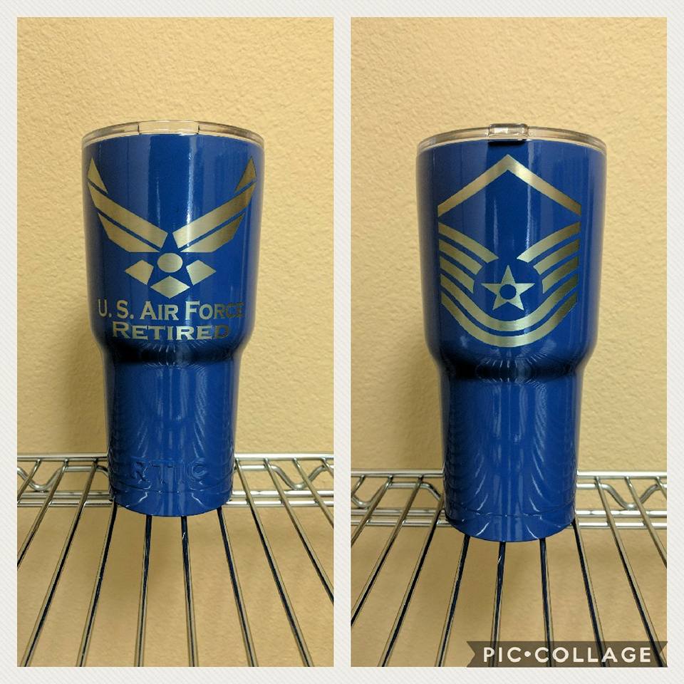 Two blue US Air Force retiree tumblers with silver logos, front and side views on a shelf.