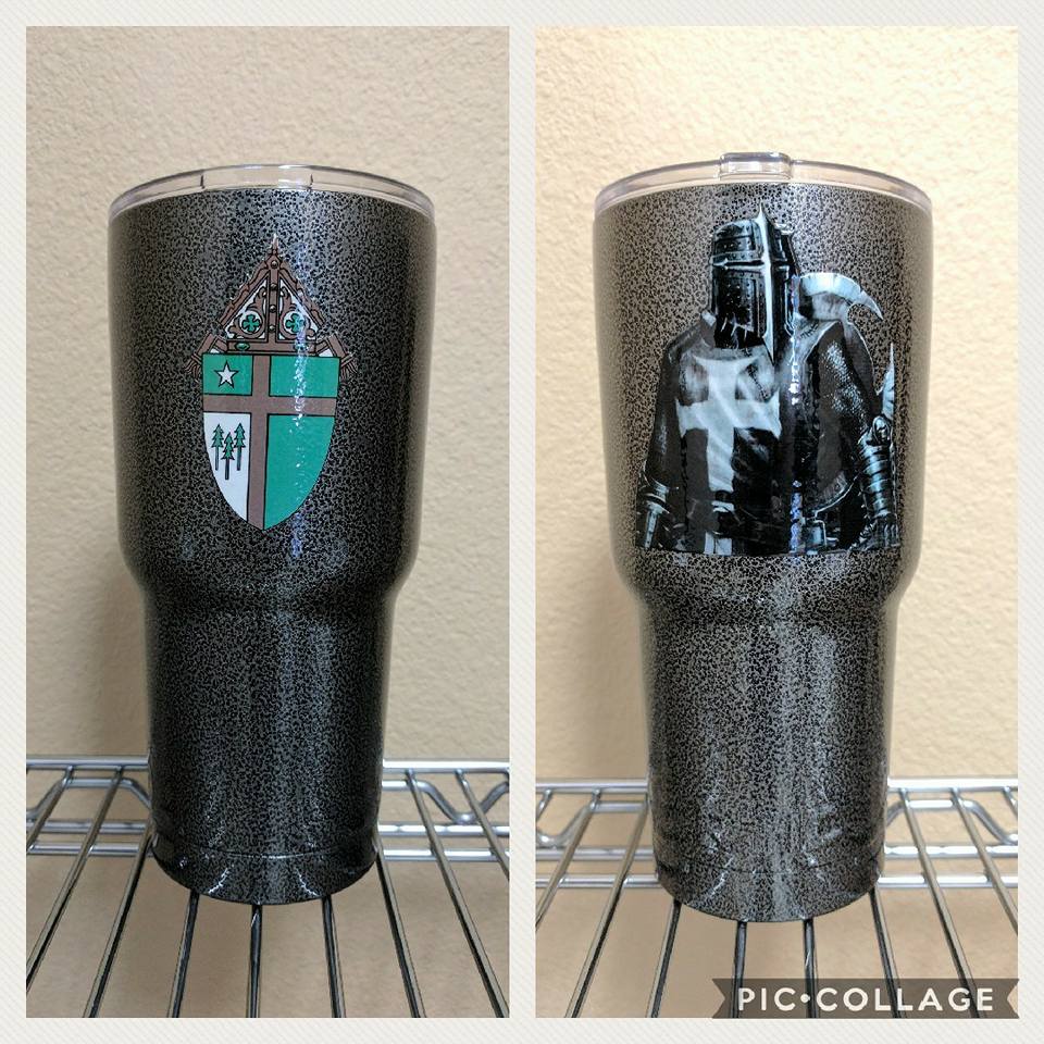 Two glitter-covered tumblers. One has a teal crest, the other a black and white knight.