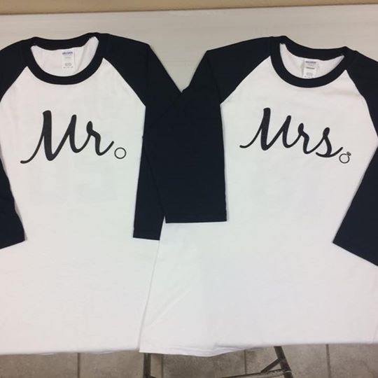 Two white and navy baseball-style shirts that read
