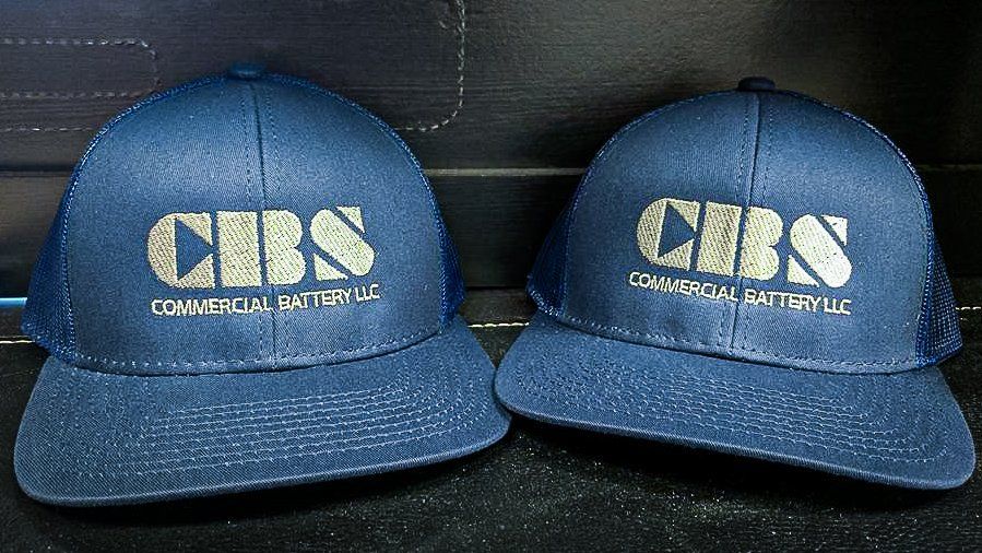 Two navy blue baseball caps with 