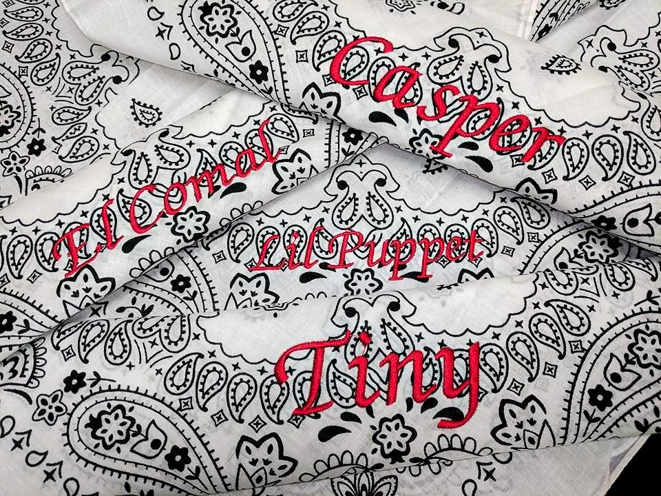 White bandanas with black paisley pattern, each embroidered with a red name: Casper, Lil' Puppet, Tiny, and Welcome.