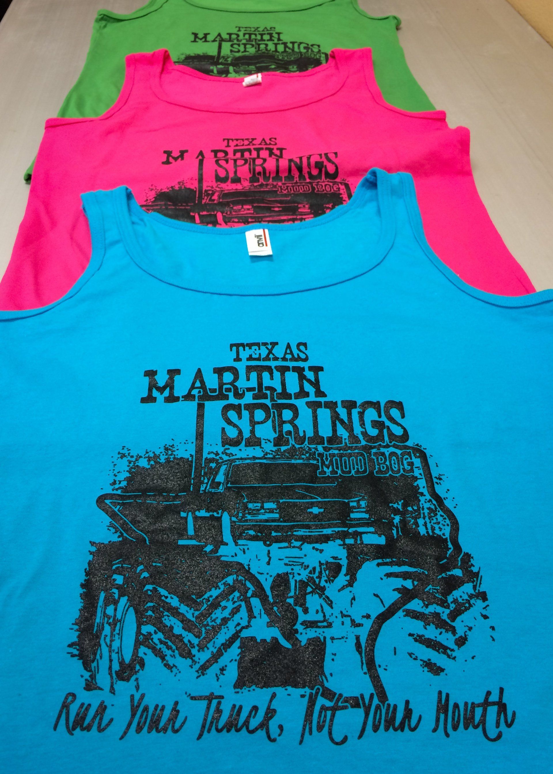 Three colorful tank tops with a printed design: Texas Martin Springs and a tractor.