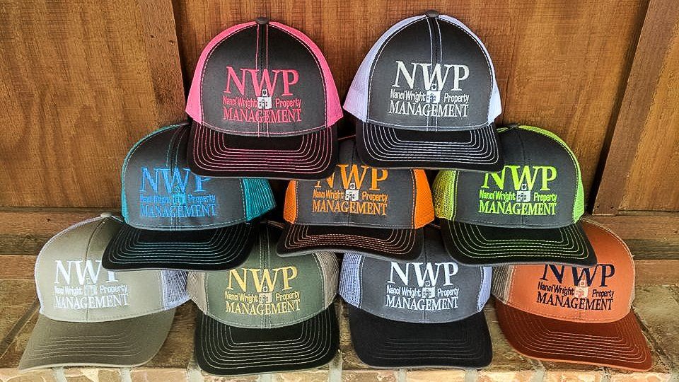Pile of trucker hats in various colors with 