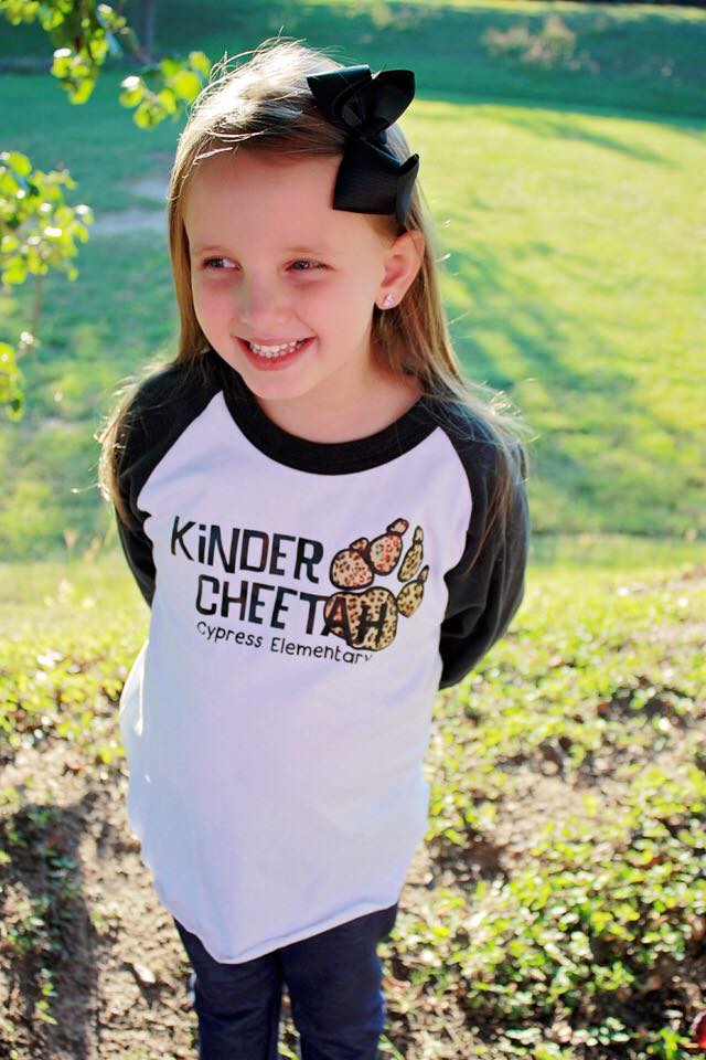 Girl smiling outdoors, wearing 