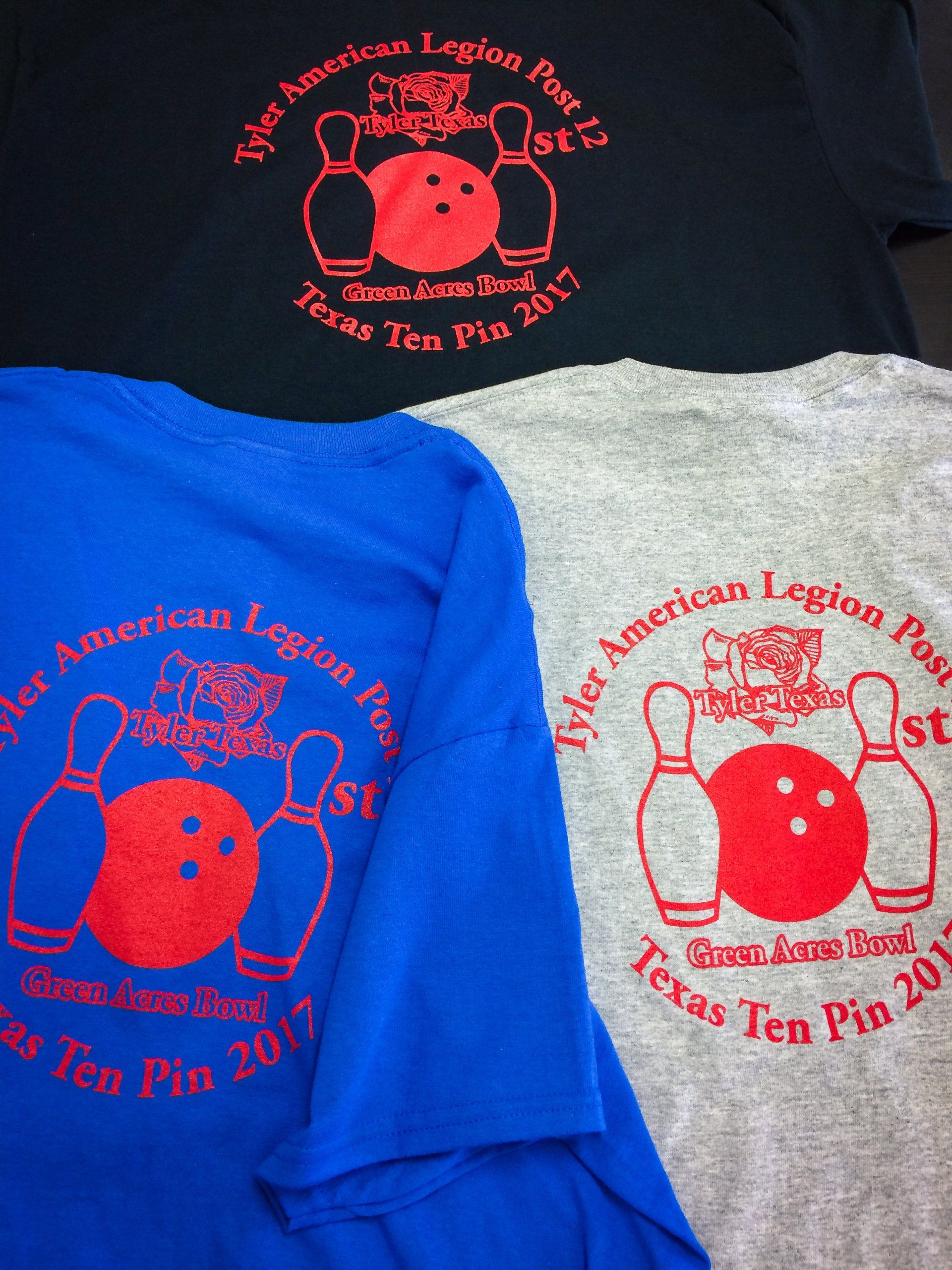 Three t-shirts: black, blue, and gray. Each displays a red bowling ball, pins, and text 