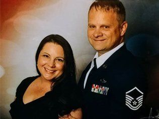 Woman and Air Force service member smiling, posed for a formal portrait.