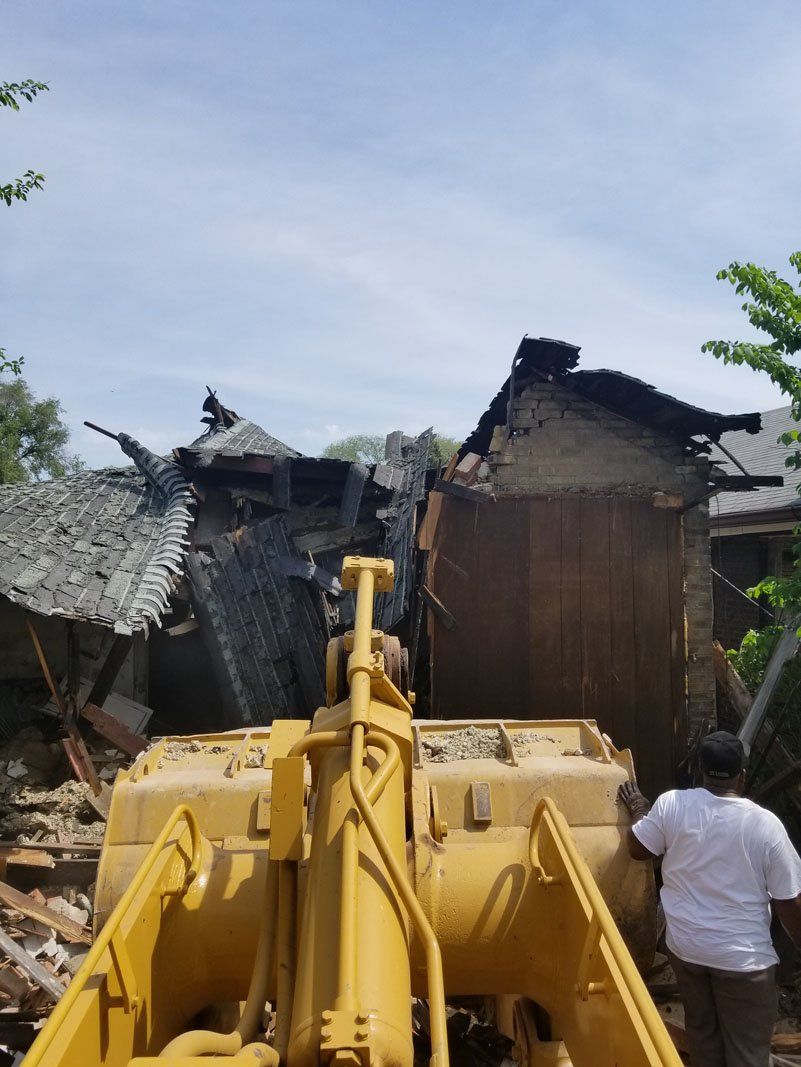 building being demolished with the help of machine