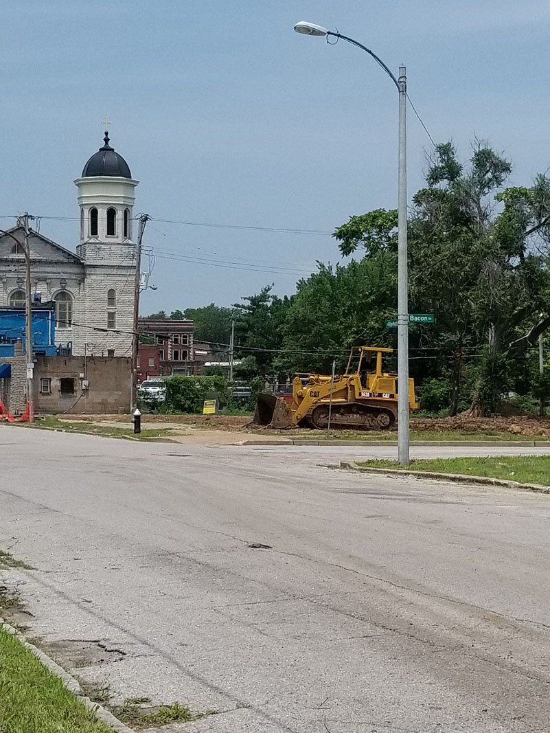 Heavy machine arriving at the demolished site