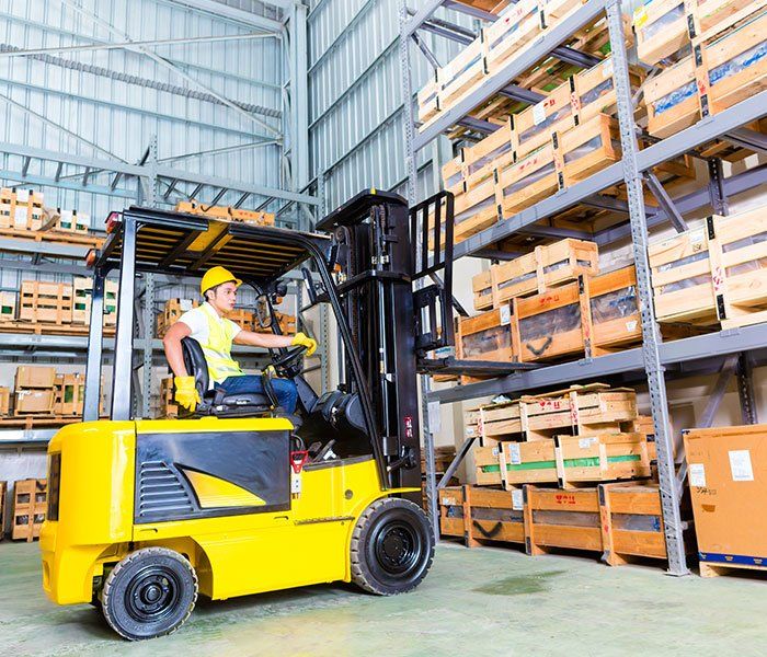 Driver Lifting Pallet In Storage — Piscataway, NJ — Central Forklift Inc. Driver Lifting Pallet In Storage — Piscataway, NJ — Central Forklift Inc.
