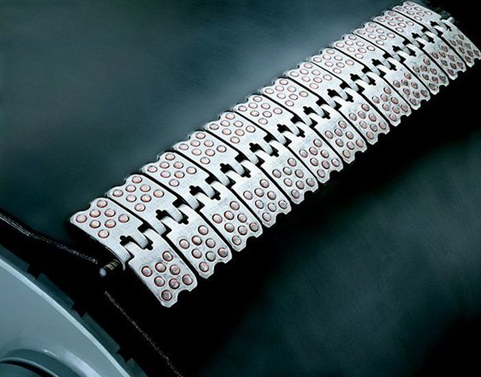 A close up of a metal belt with holes in it