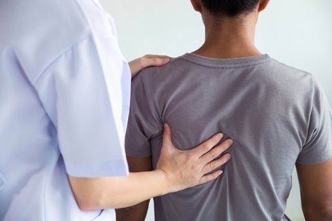 Therapist Motivating Male Patient To Walk Between Cones — Dayton, OH — Pain Evaluation & Management Center Therapist Motivating Male Patient To Walk Between Cones — Dayton, OH — Pain Evaluation & Management Center