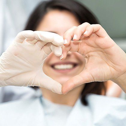 woman making heart symbol with fingers