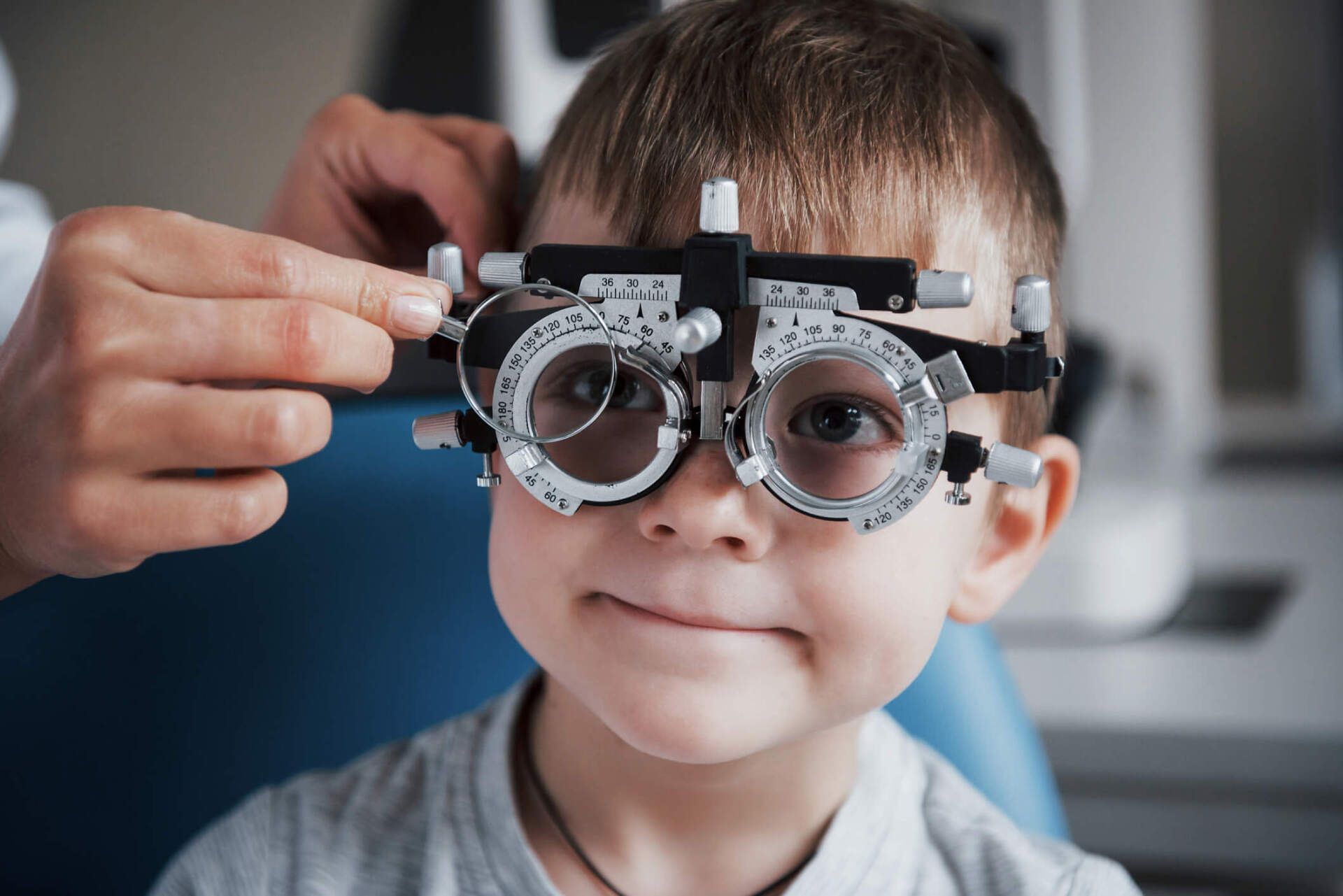 Little Boy with Phoropter — Orange, MA — Leonard Optician Inc.