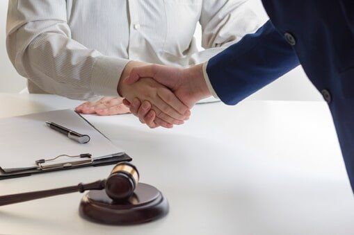Liability — Lawyer and Client Shaking Hands in Fresno, CA Liability — Lawyer and Client Shaking Hands in Fresno, CA