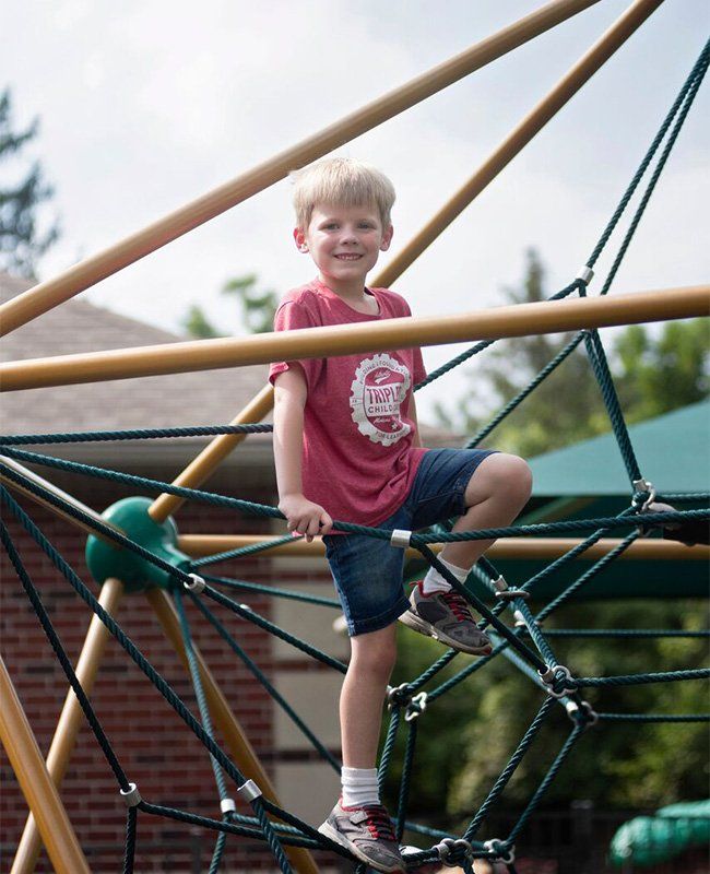 Young Boy Playing in a Park — Mokena, IL — Triple R Child Care