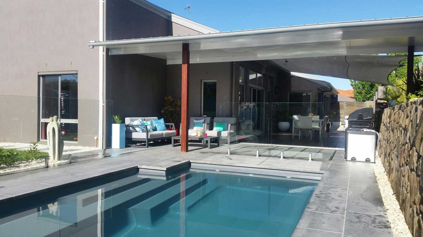 pool by pergola with metal roof