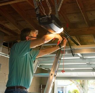 Technician repairing — Garage Door Repair Services in Flagstaff, AZ Technician repairing — Garage Door Repair Services in Flagstaff, AZ