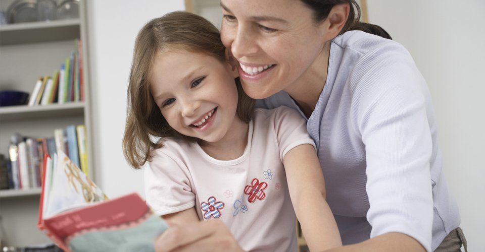 A nanny reading story to a child