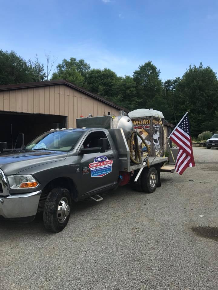 Wells Septic & Drain Cleaning Truck Carrying Portable Toilet — Delaware, OH — Wells Septic & Drain Cleaning