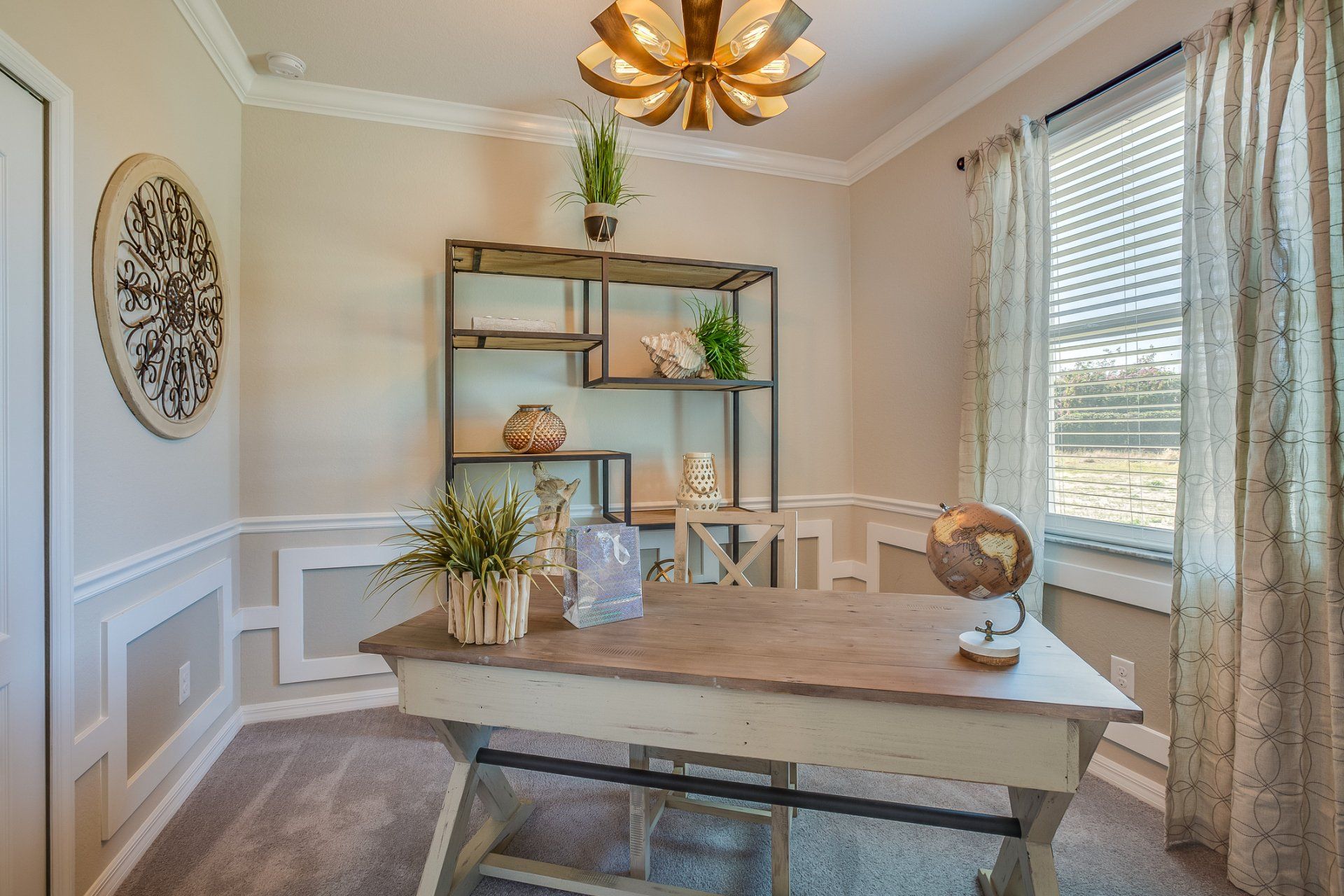 Bright dining room with wooden table, shelving, houseplants, wall art, and large windows with blinds