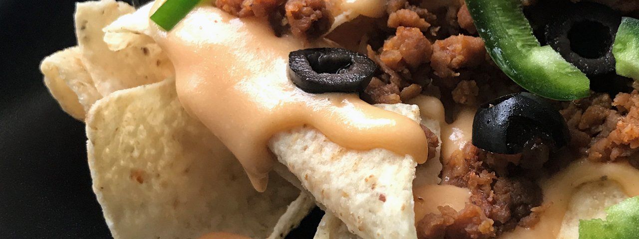 nachos close up with vegan cheese sauce