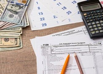 Tax forms and cash on a desk. Tax forms and cash on a desk.