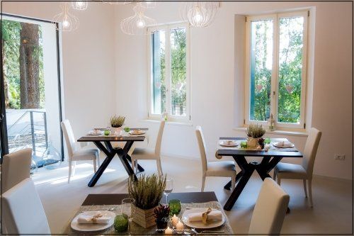 Sala in stile shabby chic con tavoli apparecchiati in legno