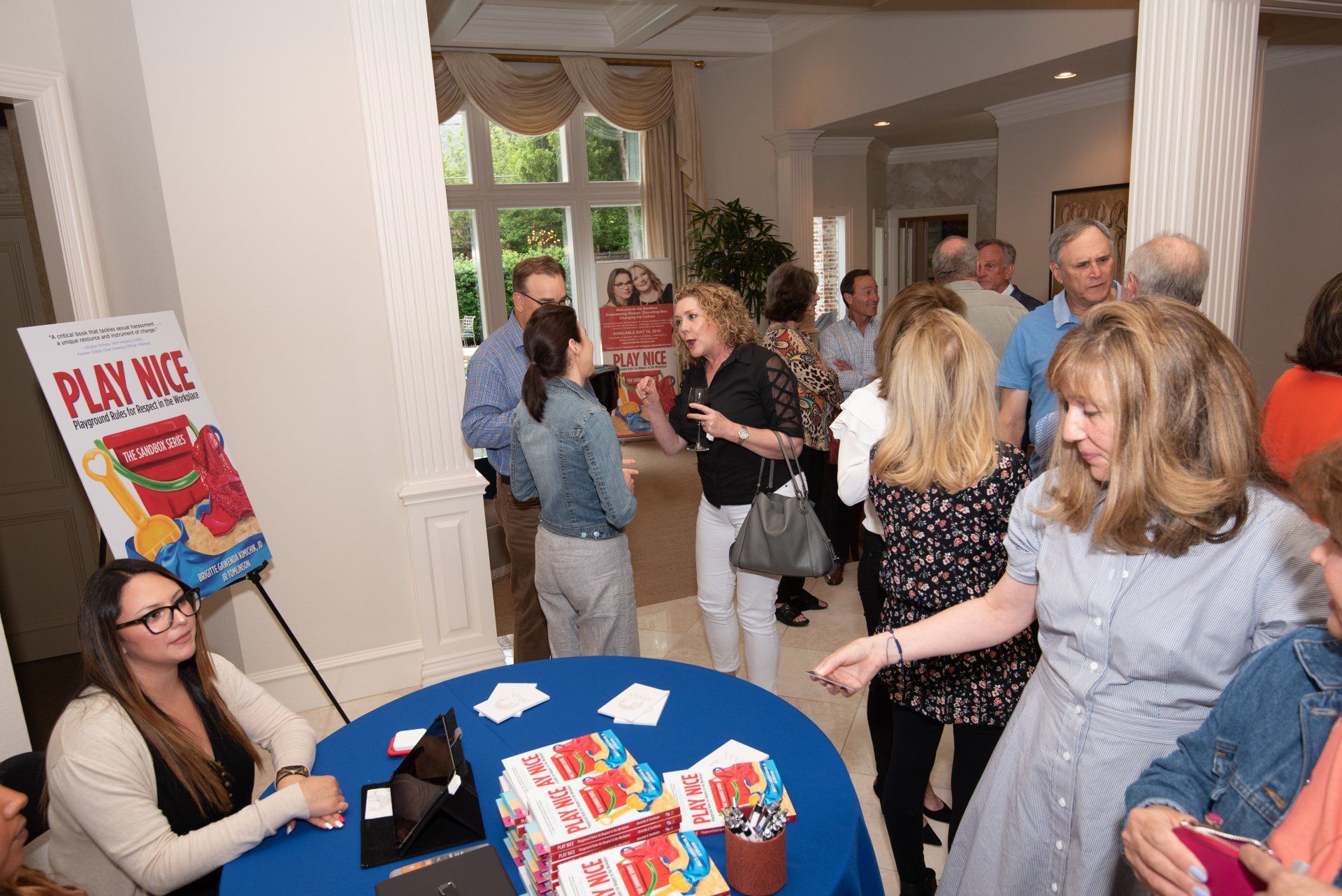 A group of people are standing around a table in a room.