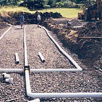 Gecko Enterprises employees working on septic pipework