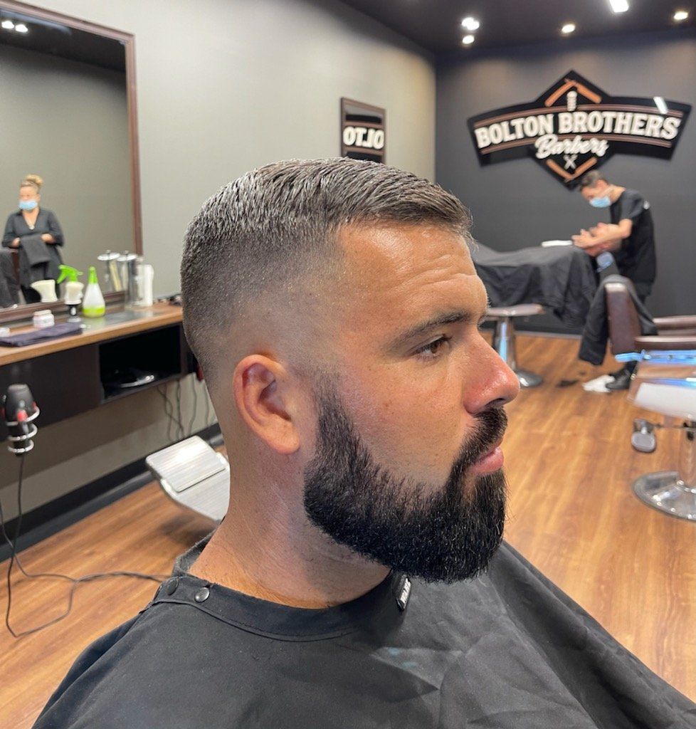 Man In Barber Chair With Fade Haircut And Beard — Bolton Brothers Barbers in Erina, NSW