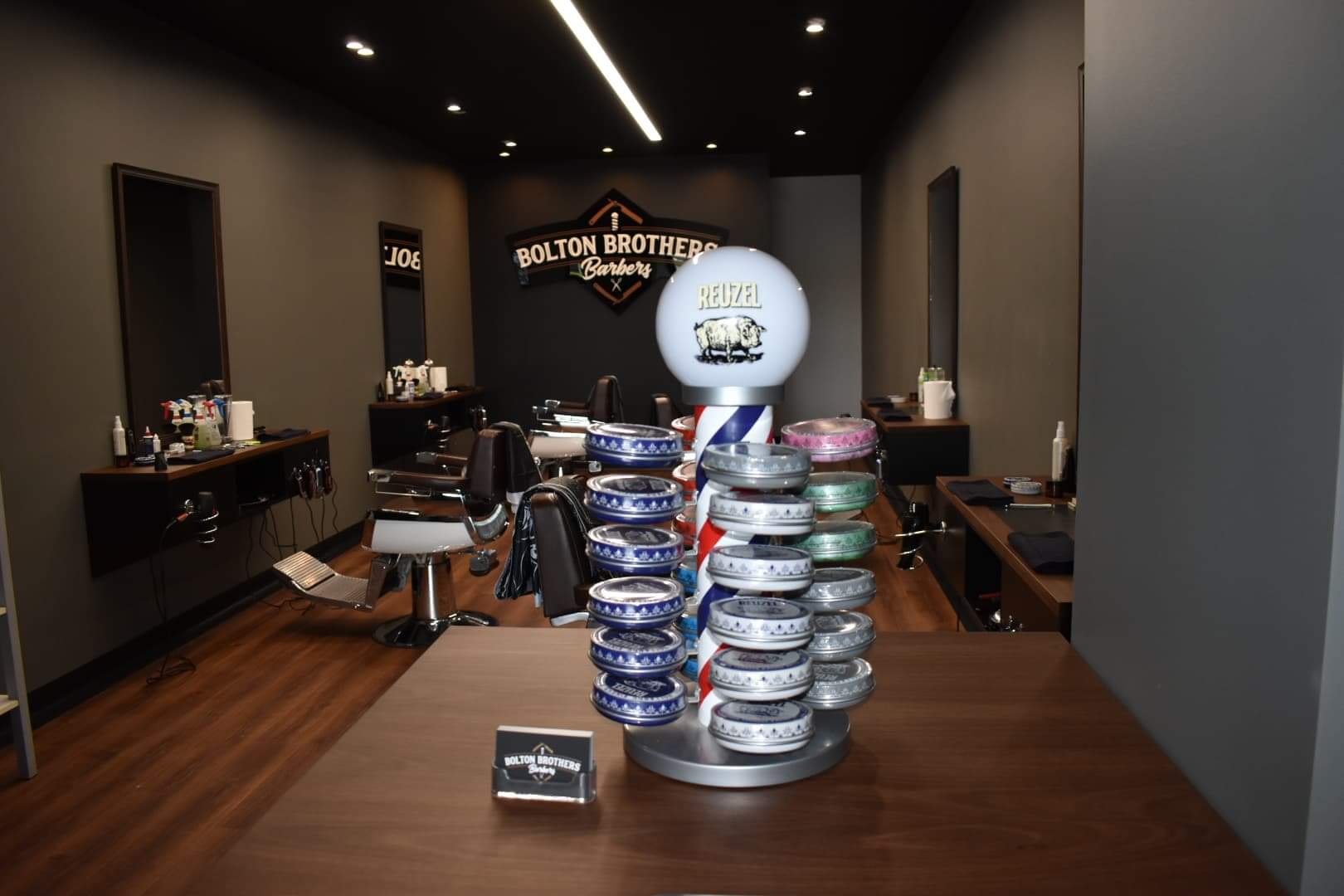 Barbershop Product Display With Chairs And Mirrors — Bolton Brothers Barbers in Erina, NSW