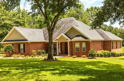 Home Roof Repair — Brick Colored Residential House in Northeast FL Home Roof Repair — Brick Colored Residential House in Northeast FL