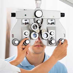 Optometrist — Optometrist Adjusting Phoropter For Patient in Lawton, OK Optometrist — Optometrist Adjusting Phoropter For Patient in Lawton, OK
