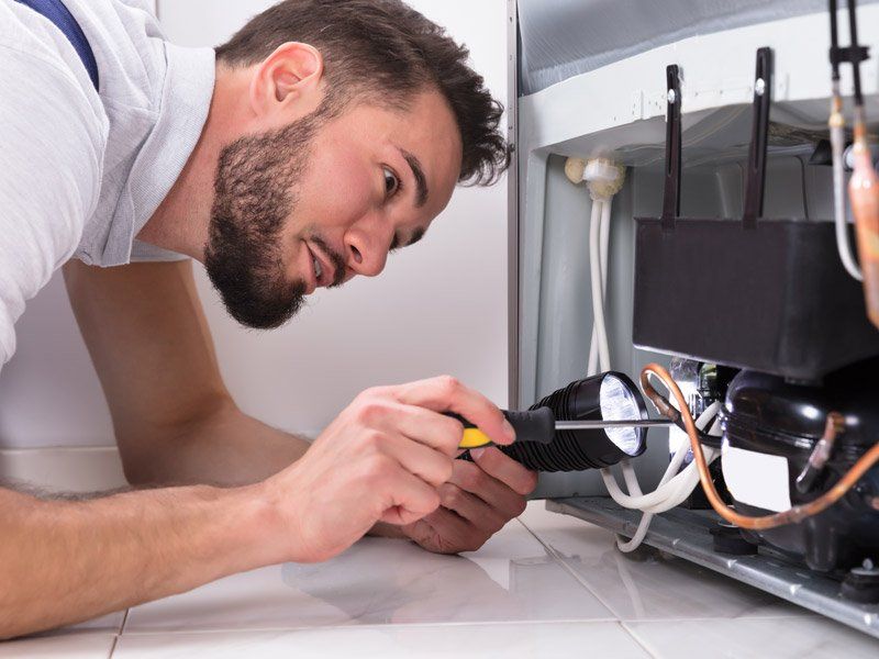 electrician working on appliance