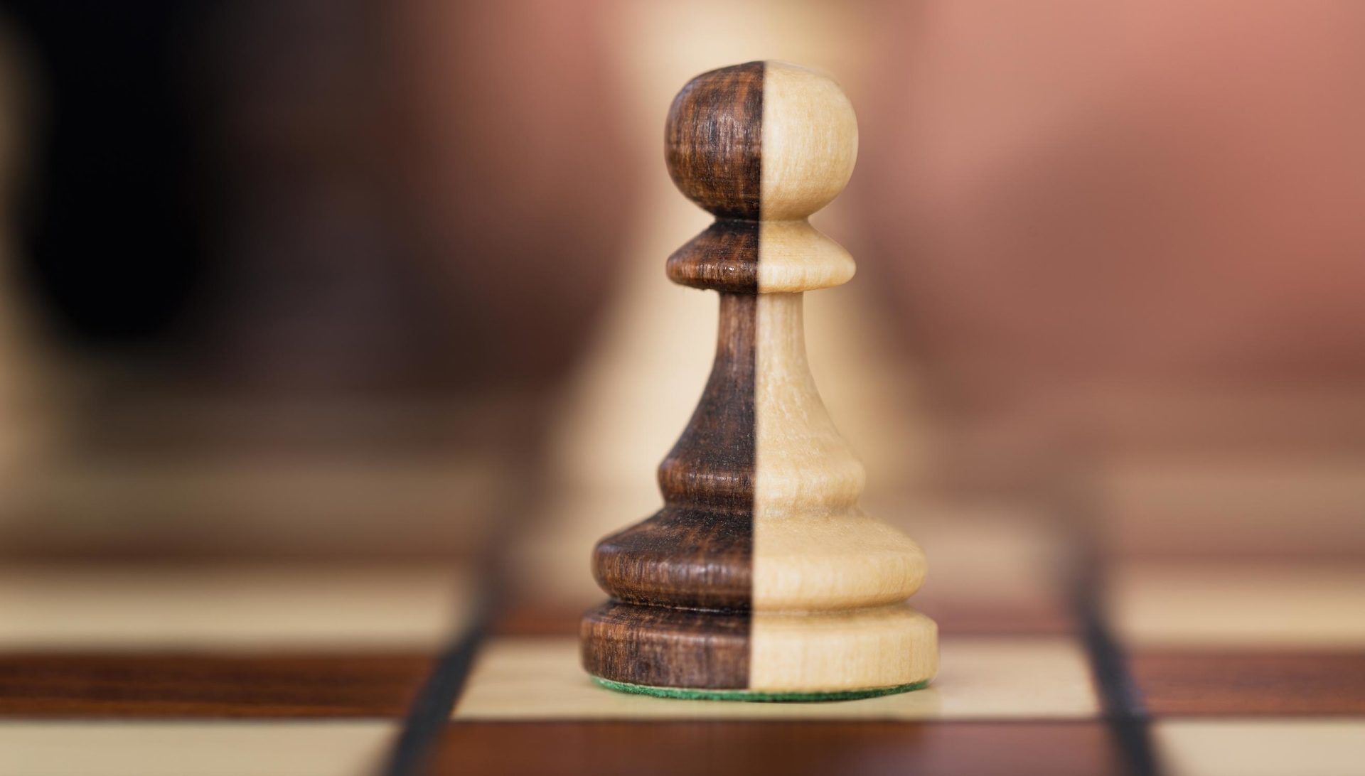 Two colored pawn on a chess board