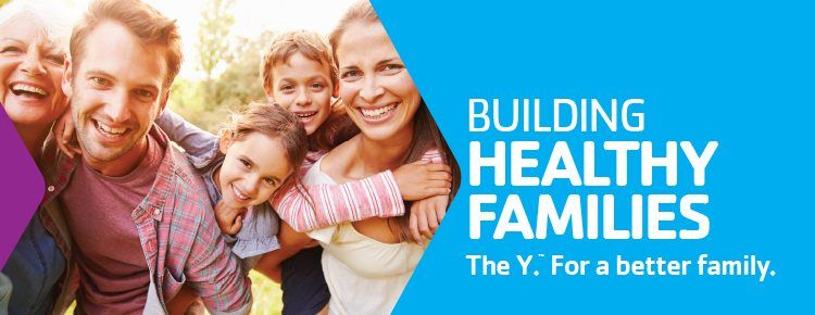 Family smiling in a gym, with text reading “Building Healthy Families. The Y: For a better family.”