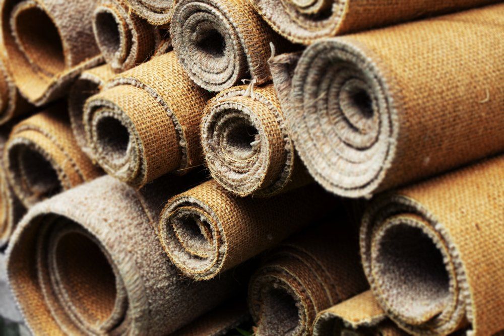 Rolls of carpet piled on top of each other