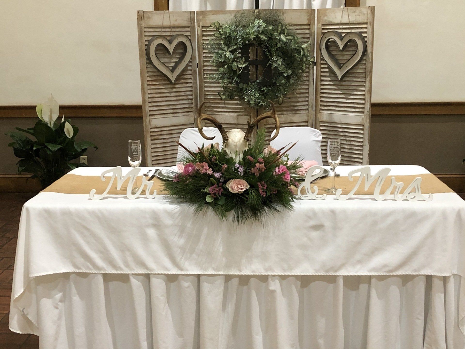 Wedding reception head table with floral arrangement, 