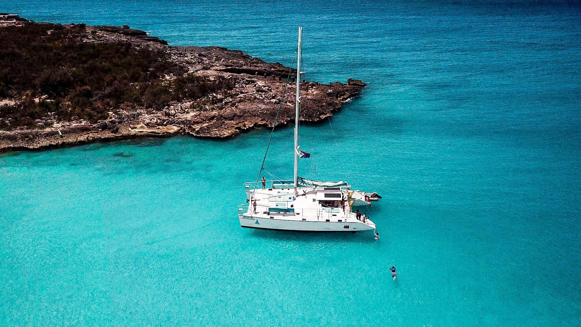 Random Wind catamaran anchored in Caribbean cove