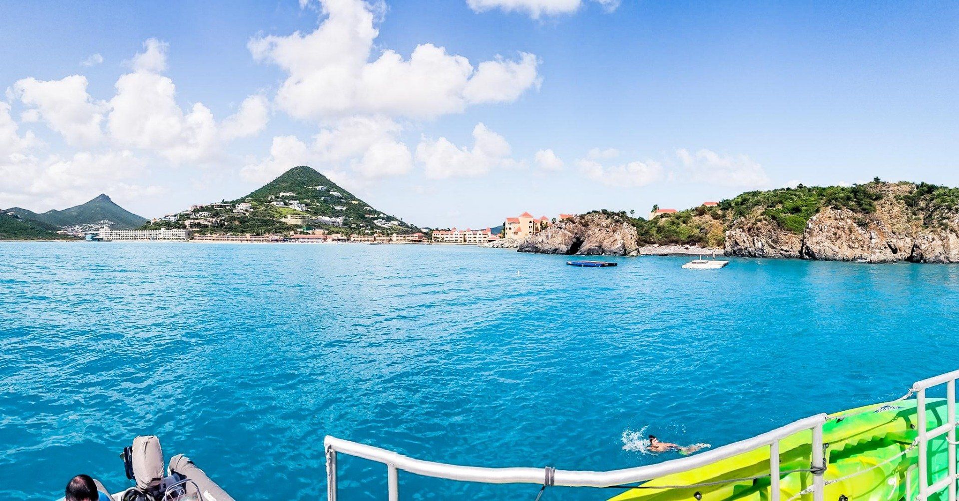 picture taken from boat of island mountains and body of water