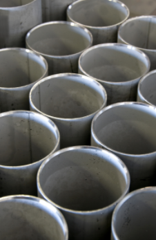 Rows of empty gray metal pipes viewed from above