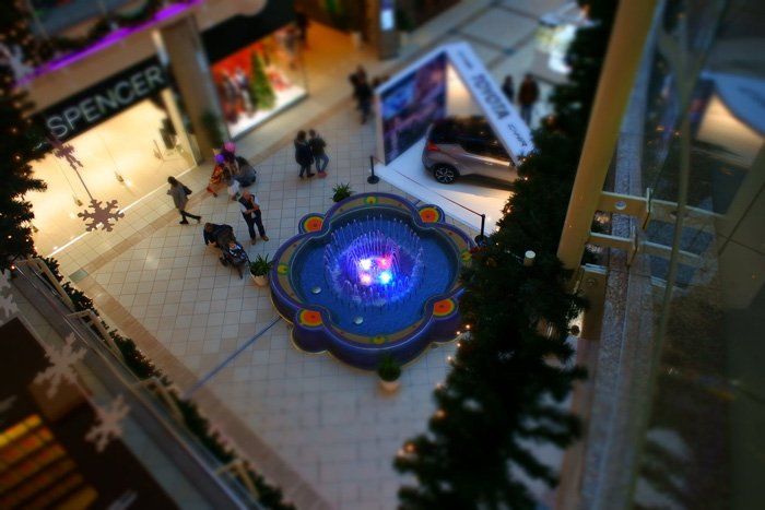 An aerial view of a shopping mall with a spencer store in the background