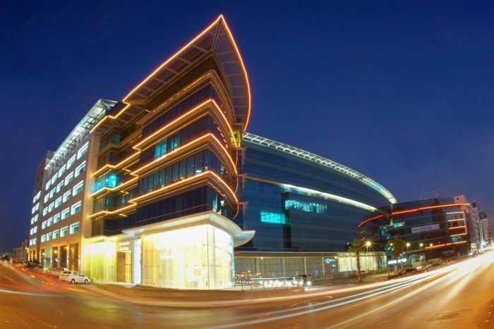A large building with a lot of windows is lit up at night.