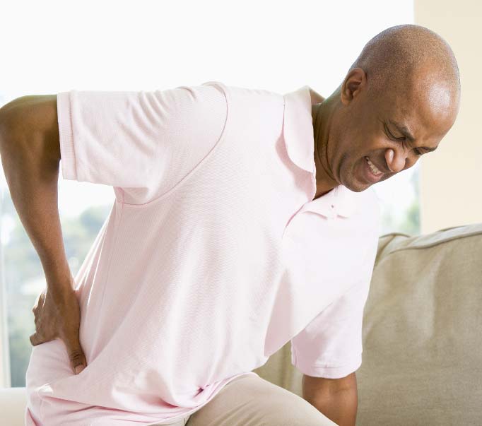 Man with Back Pain Seeks Back Pain Treatment at Living Well Chiropractic Clinic Salina Kansas
