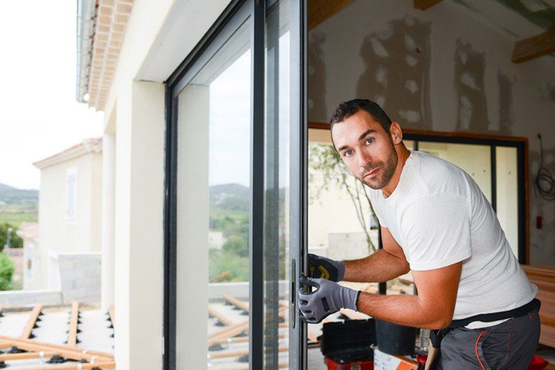 man looking outside open window