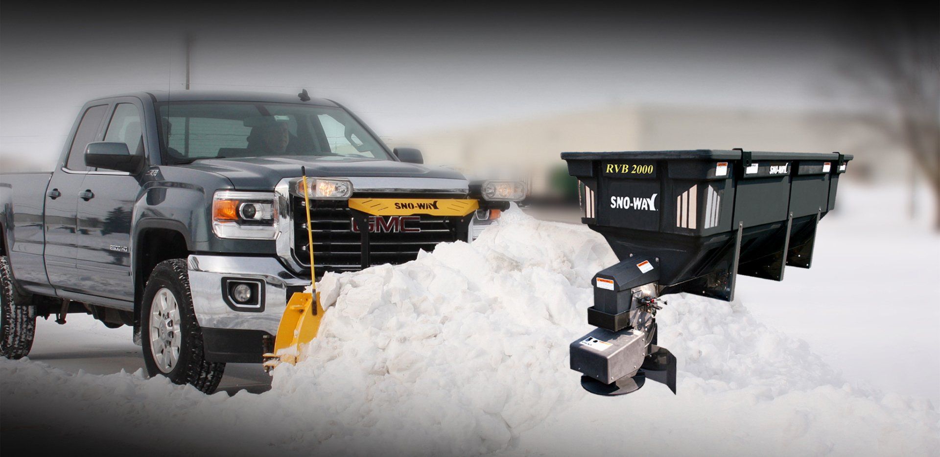 A truck is plowing snow with a plow attached to it.