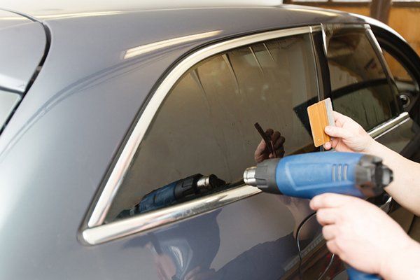 Applying Tinting Foil on a Car Window — Converse, TX — Quality Master Auto Glass