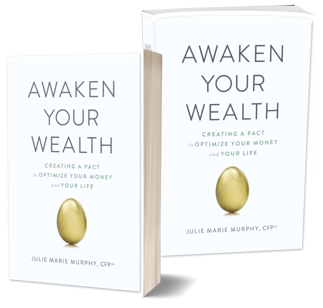 Two copies of the book awaken your wealth are sitting next to each other.