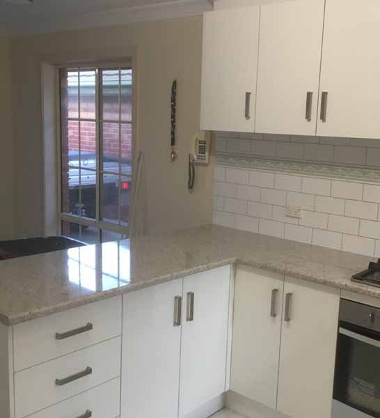 after kitchen with dark counter tops